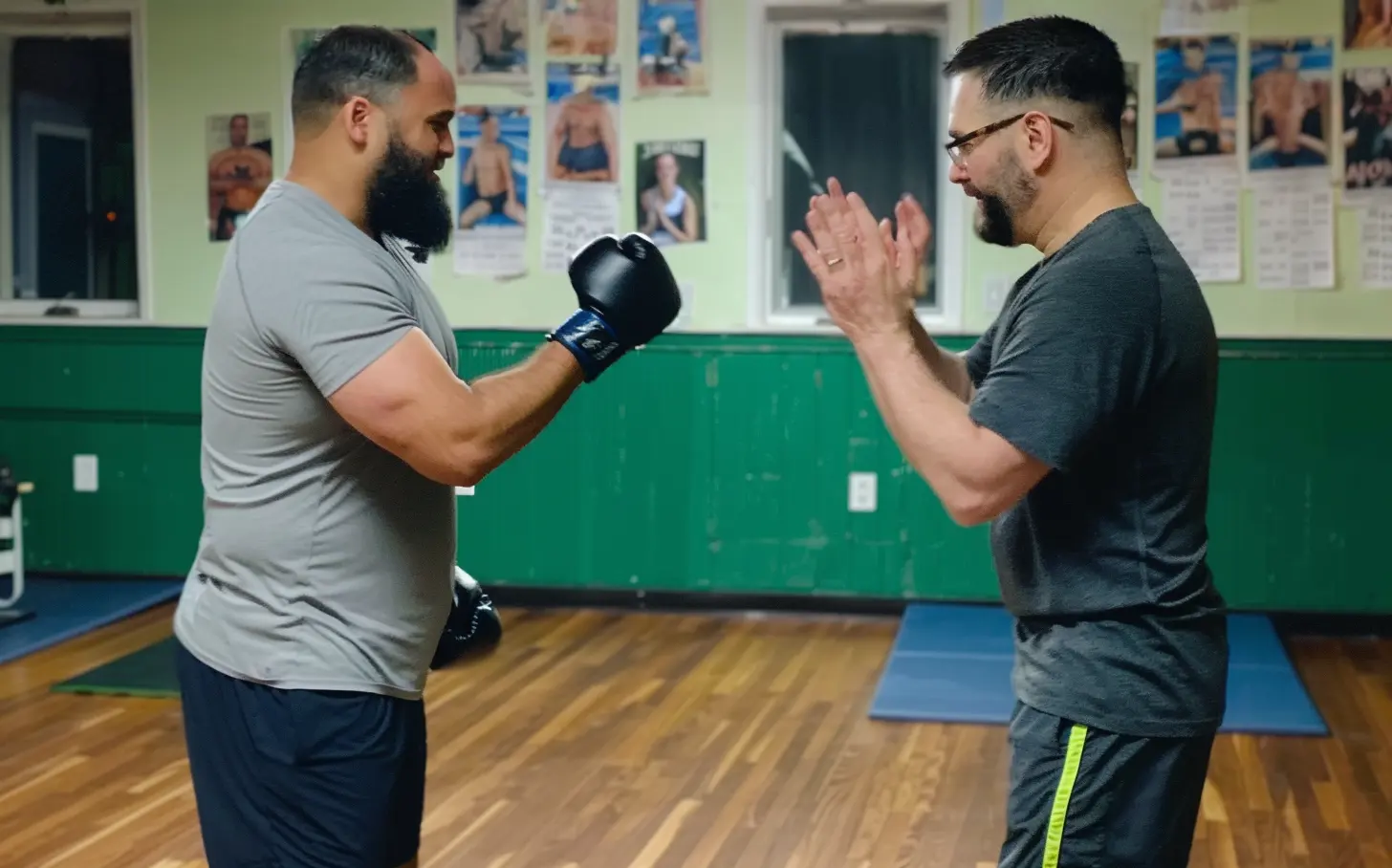 a martial arts instructor is teaching Safety in Martial Arts to one of his students 