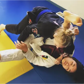 picture of two women fighting in a defensive guard position at River City Warriors in Portland Oregon
