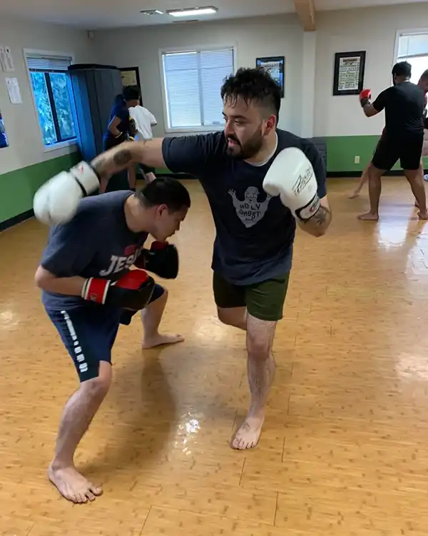 demonstration of rolling punches in muay thai at River City Warriors Tigard